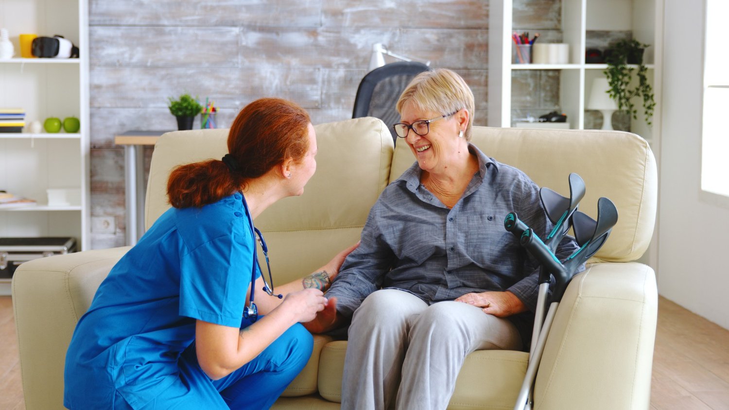 female caregiver providing 24 hour care service to an old woman